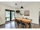 This dining room features a rustic table, modern chairs, and a door that leads to the outside patio at 1280 Casco Bay Cir, Cicero, IN 46034