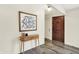 The foyer features wood floors, a wooden door, and a console table with a mirror at 1280 Casco Bay Cir, Cicero, IN 46034