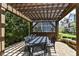 Outdoor dining area under a pergola with a large table and chairs at 13316 E Lieder Way, Fishers, IN 46037