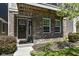 Charming front entry with dark brick, detailed door, and lovely landscaping at 13316 E Lieder Way, Fishers, IN 46037