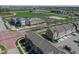 Aerial view showcasing townhomes, commercial spaces, and streetscape within the community at 13316 E Lieder Way, Fishers, IN 46037