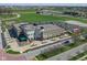 An aerial view highlights the commercial area, green fields, and well-maintained landscaping at 13316 E Lieder Way, Fishers, IN 46037
