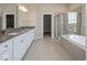 A spacious bathroom includes a double sink vanity, tile flooring, and a separate shower and tub at 13316 E Lieder Way, Fishers, IN 46037