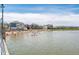 A sunny view of the community lake and beach, with residents enjoying swimming and sunbathing at 13316 E Lieder Way, Fishers, IN 46037