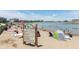 Community beach with beachgoers, rules signage, and lake views at 13316 E Lieder Way, Fishers, IN 46037