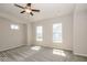 A bright, carpeted bedroom is illuminated with lots of natural light from the multiple windows at 13316 E Lieder Way, Fishers, IN 46037