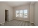 A bright, carpeted bedroom is illuminated with lots of natural light and a doorway to the bathroom at 13316 E Lieder Way, Fishers, IN 46037