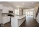 Modern kitchen with white cabinets, stainless steel appliances, and large center island at 13316 E Lieder Way, Fishers, IN 46037