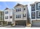 Modern three-story townhome with a garage and ample windows at 13316 E Lieder Way, Fishers, IN 46037