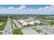 Aerial view showcases a comprehensive high school campus, complete with parking, sports fields, and academic buildings at 13510 E 131St St, Fishers, IN 46037