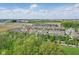 Aerial perspective features a neighborhood of townhouses nestled near commercial zones and mature trees at 13510 E 131St St, Fishers, IN 46037