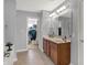 Bright bathroom featuring double sink vanity, large mirror, and access to the walk-in closet at 13510 E 131St St, Fishers, IN 46037
