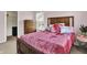 Cozy bedroom with natural light, a wood frame bed, and a wooden dresser at 13510 E 131St St, Fishers, IN 46037