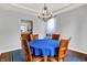 Elegant dining room with hardwood floors, chandelier, and view to the kitchen from the open layout at 13510 E 131St St, Fishers, IN 46037