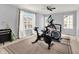 Bright exercise room with two windows, a ceiling fan, and both elliptical and exercise bikes at 13510 E 131St St, Fishers, IN 46037