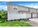Townhouse exterior featuring a fenced patio, garage, and well-maintained landscaping at 13510 E 131St St, Fishers, IN 46037