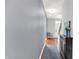 Inviting hallway with hardwood floors and a decorative rug leading to the main entrance of the home at 13510 E 131St St, Fishers, IN 46037