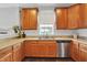 Bright and spacious kitchen with warm wood cabinetry, stainless steel appliances, and a large window above the sink at 13510 E 131St St, Fishers, IN 46037
