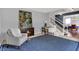 Cozy living area with a stylish desk, a blue patterned rug, and a staircase leading to the upper level at 13510 E 131St St, Fishers, IN 46037