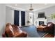Comfortable living room features a fireplace, hardwood floors, and a stylish area rug at 13510 E 131St St, Fishers, IN 46037