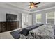 Relaxing main bedroom featuring a tray ceiling, a TV, and a charming window seat at 13510 E 131St St, Fishers, IN 46037
