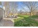 Expansive backyard with lush green grass, a cozy patio set, and a well-maintained wooden fence at 1417 Macintosh Ct, Avon, IN 46123