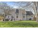 Large backyard showcasing the house exterior, a patio with outdoor seating, and a well-maintained lawn at 1417 Macintosh Ct, Avon, IN 46123