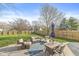 Spacious backyard featuring a patio, outdoor seating, a wooden fence, and lush green grass at 1417 Macintosh Ct, Avon, IN 46123