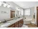 Bright bathroom featuring a double vanity, granite countertops, soaking tub, and ample lighting at 1417 Macintosh Ct, Avon, IN 46123
