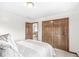 Cozy bedroom featuring natural light, wooden closet doors, and neutral-colored walls at 1417 Macintosh Ct, Avon, IN 46123