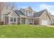 Charming two-story home with brick accents and a well-manicured lawn at 1417 Macintosh Ct, Avon, IN 46123