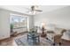 Inviting living room with comfortable seating, a large window, and a ceiling fan for a relaxing ambiance at 1417 Macintosh Ct, Avon, IN 46123