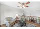 Comfortable seating in a cozy upper living area with a vintage rug, ceiling fan and a view of the stairs at 1417 Macintosh Ct, Avon, IN 46123