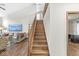 Elegant wooden staircase leading to the upper level, with views of the living room at 1417 Macintosh Ct, Avon, IN 46123