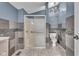 Neutral toned bathroom with shower, mosaic tile accents, and modern lighting fixture at 143 W Washington St, Mooresville, IN 46158