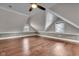 Spacious attic bedroom with vaulted ceilings, wood floors, and natural light at 143 W Washington St, Mooresville, IN 46158