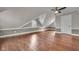 Spacious attic bedroom with vaulted ceilings, wood floors, and paneled walls at 143 W Washington St, Mooresville, IN 46158