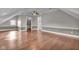 Spacious attic bedroom with vaulted ceilings, wood floors, and recessed lighting at 143 W Washington St, Mooresville, IN 46158