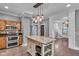 Bright kitchen featuring a granite island, stainless appliances, and an open layout leading to stairs at 143 W Washington St, Mooresville, IN 46158