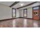 Spacious living room featuring wood floors, exposed beams, trim work, and ample natural light at 143 W Washington St, Mooresville, IN 46158