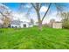Spacious backyard with green grass, a shed, a patio with seating, and a mature tree at 1508 Douglas Dr, Franklin, IN 46131