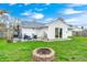 A charming backyard includes a fire pit and a patio featuring outdoor seating and a grill at 1508 Douglas Dr, Franklin, IN 46131
