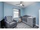 Welcoming Bedroom with blue walls, a cozy gray chair, and a matching crib with changing table at 1508 Douglas Dr, Franklin, IN 46131