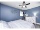 Charming bedroom with a gray ceiling fan, a dresser with a cat tree, and a large bed at 1508 Douglas Dr, Franklin, IN 46131