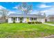 Charming single-story home with a well-maintained lawn, tidy landscaping, and a welcoming yellow front door at 1508 Douglas Dr, Franklin, IN 46131