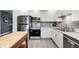 Modern kitchen with stainless steel appliances, white cabinetry, granite countertops, and ample storage at 1508 Douglas Dr, Franklin, IN 46131