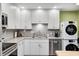 Well-lit kitchen with granite countertops, white cabinets, stainless steel appliances, and a double sink at 1508 Douglas Dr, Franklin, IN 46131