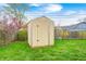 Exterior shot of a backyard shed and swing set on a grassy lawn with partial fence at 1508 Douglas Dr, Franklin, IN 46131