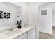 Bathroom featuring a double sink vanity with a white countertop, modern fixtures, and decorative mirror at 15379 Alperton Rd, Fishers, IN 46037