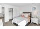 Bright bedroom with a shiplap accent wall, plush bedding, bedside tables, and closet with sliding doors at 15379 Alperton Rd, Fishers, IN 46037